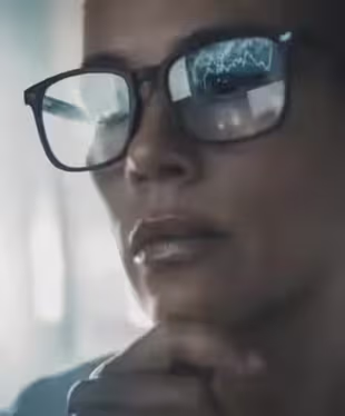 Close-up portrait with reflections of trading data.