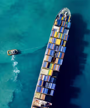 Aerial view of a vessel crossing open waters.