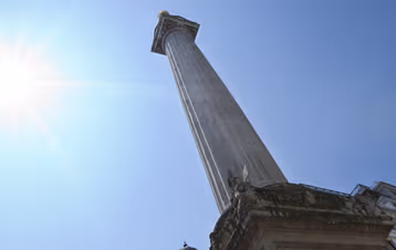 Nelson's Column rising into a clear blue sky in London.
